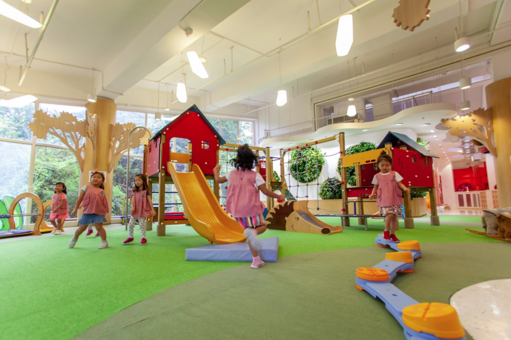 Children playing around in the preschool indoor playground