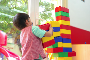 A child playing with building blocks in Montessori class