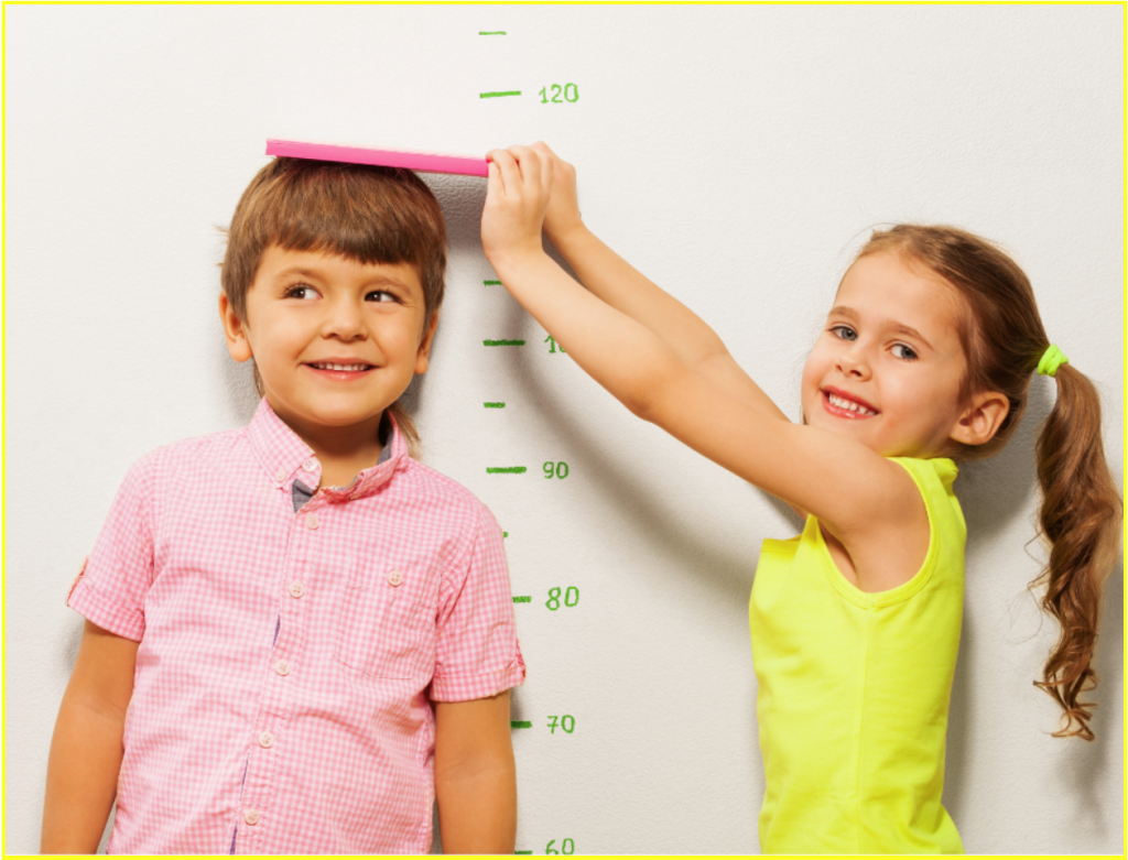 two kids measuring their heights