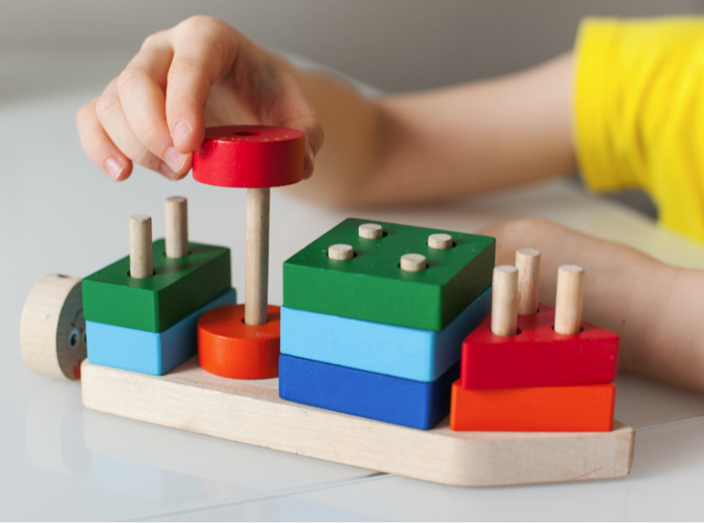 a preschooler playing shape scavenger