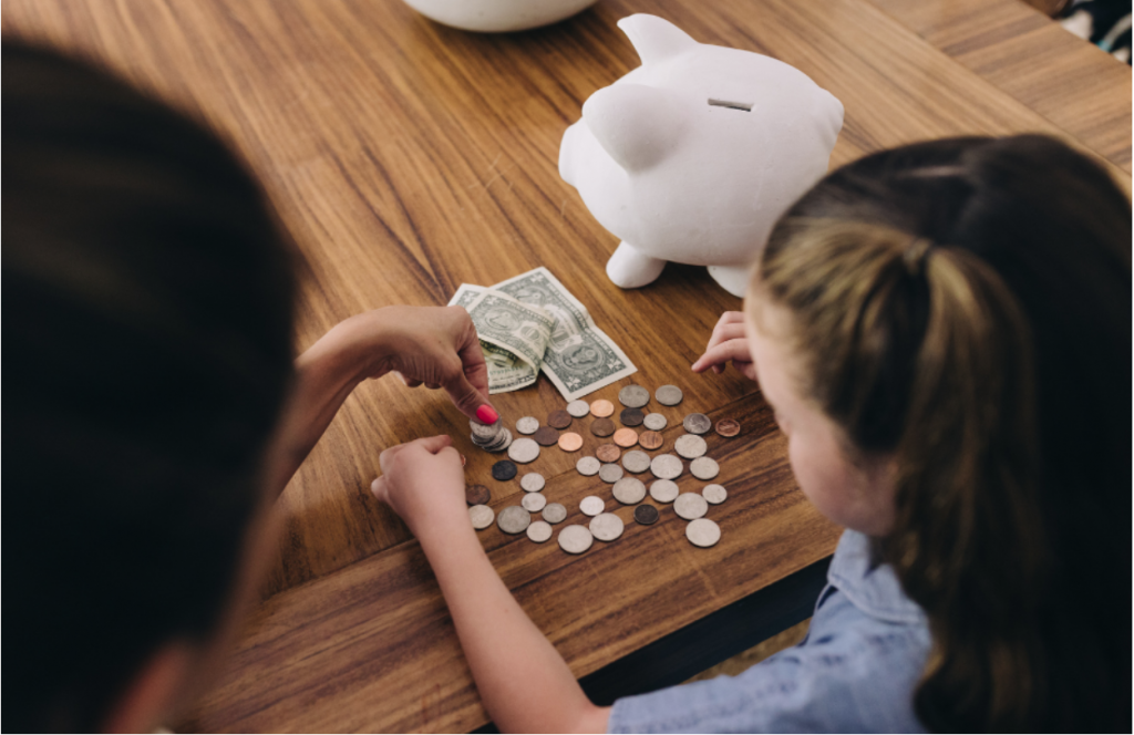 Parent teaching her child to count money