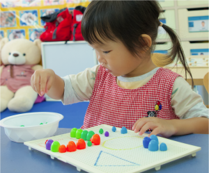 a girl is focusing on her math game