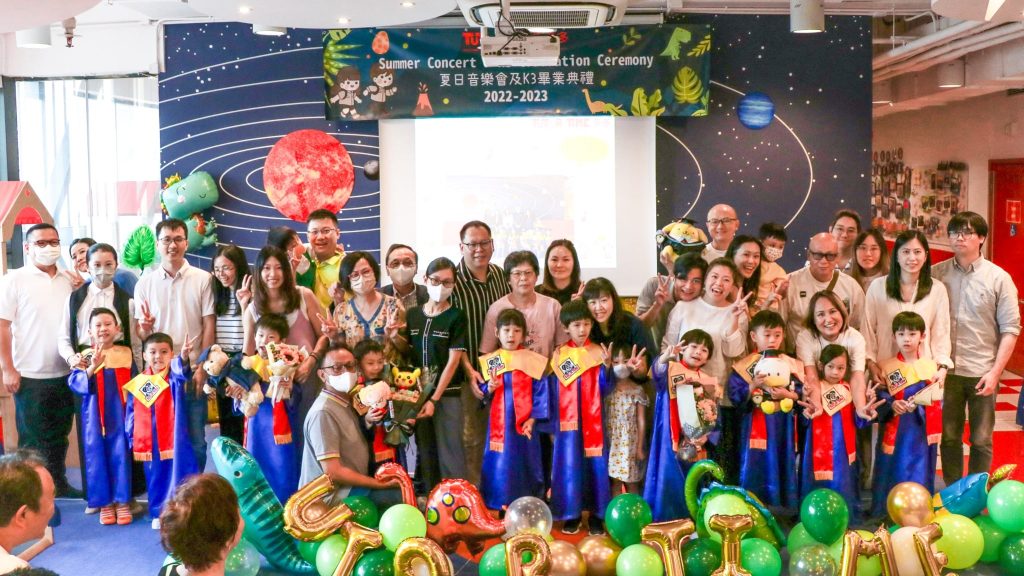 Tutor Time’s graduates in attire with adults at a graduation ceremony